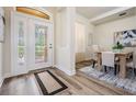 Inviting foyer featuring a decorative glass front door, with dining room views at 2665 Lakebreeze N Ln, Clearwater, FL 33759