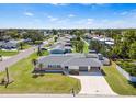 Aerial view of a well-maintained single Gathering home with a large front lawn and concrete driveway at 269 Algiers Dr, Venice, FL 34293