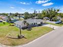 Charming single-story home with a well-manicured lawn and a classic brick accent wall at 269 Algiers Dr, Venice, FL 34293