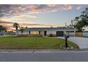 Charming single-story home with a well-manicured lawn and a classic brick accent wall at 269 Algiers Dr, Venice, FL 34293