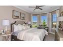 Serene bedroom featuring large windows, elegant decor, and ample natural light at 29845 Imperati Blvd, Wesley Chapel, FL 33543