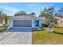 Inviting single-story home featuring a covered entry and a spacious driveway at 4331 Foxboro Dr, New Port Richey, FL 34653