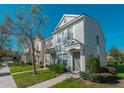 Inviting two-story townhome with a well-maintained lawn, and a cozy, covered front entrance at 4535 Kennewick Pl, Riverview, FL 33578