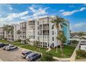 Condominium complex with screened balconies, lush landscaping, and convenient parking at 4904 38Th S Way # 316, St Petersburg, FL 33711