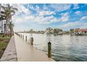 Scenic waterfront view of a canal with a long wooden pier and beautiful homes in the background at 4904 38Th S Way # 316, St Petersburg, FL 33711