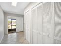 Bright foyer featuring tiled floors, bi-fold closet, view of screened front door, and access to the rest of the home at 709 Flamingo Dr, Apollo Beach, FL 33572