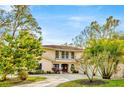 Beautiful two-story home with a balcony, manicured lawn, and charming curb appeal at 7201 Hodgewood Ct, Tampa, FL 33614