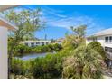 Scenic exterior view showcasing a tranquil waterway surrounded by lush greenery and neighboring condos at 9960 5Th St. N. # 304, St Petersburg, FL 33702