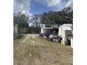 Exterior daytime view of a white, single-story home at 11616 Bullfrog Creek Rd, Gibsonton, FL 33534