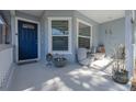 Inviting front porch with cozy seating, decorative plants, and a charming view at 1164 Engman St, Clearwater, FL 33755