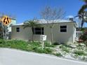 Single story home with metal roof and minimal landscaping on a sunny day at 19109 Gulf Blvd, Indian Shores, FL 33785