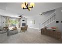 Bright living room featuring a fireplace, wood floors, and sliding glass doors to a balcony at 19651 Gulf Blvd # A6, Indian Shores, FL 33785
