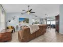 Bright living room with high ceilings, ceiling fan, tile flooring, and plenty of natural light at 2009 Sheffield Ct, Oldsmar, FL 34677