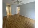 This bright bedroom offers hardwood floors, ceiling fan, and access to the ensuite bathroom at 2131 Ridge S Rd # 86, Largo, FL 33778