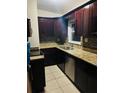Kitchen boasts granite countertops, stainless steel appliances, and dark wood cabinets at 4108 55Th N Ave, St Petersburg, FL 33714