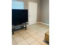 Open living space with tiled floors featuring a TV and storage trunk at 4108 55Th N Ave, St Petersburg, FL 33714