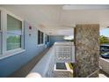 Hallway featuring a light blue wall and white geometric designed railing, leading to a rock facade at 4715 Bay Ne St # 323, St Petersburg, FL 33703