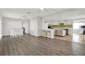 Spacious living area with hardwood floors and an open layout to the kitchen, perfect for entertaining at 5613 19Th S Ave, Gulfport, FL 33707