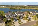 Stunning aerial view showcases the home's proximity to a serene lake and community at 7221 Nightshade Dr, Riverview, FL 33578