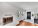 Bright living room featuring a fireplace, hardwood floors, and ample natural light at 11718 N Ola Ave, Tampa, FL 33612