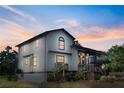 Exterior view of a two-story home with well-maintained landscaping and a scenic sky at 130 80Th Ne Ave, St Petersburg, FL 33702