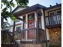 Inviting front entrance featuring a covered porch, wooden details, and decorative stained glass windows at 130 80Th Ne Ave, St Petersburg, FL 33702