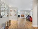 Bright entryway featuring wood floors, decorative vases, and modern wall art at 1426 75Th Ne Cir, St Petersburg, FL 33702