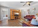 Relaxing living room with wood floors, media center, and stylish modern furniture at 1426 75Th Ne Cir, St Petersburg, FL 33702