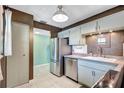 A cozy kitchen featuring stainless steel appliances, tiled floor, and ample cabinet space at 19029 Us Highway 19 N # 1-22, Clearwater, FL 33764