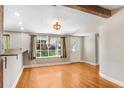 Bright living area with hardwood floors, a large window, and access to the home's exterior at 19531 Deer Lake Rd, Lutz, FL 33548