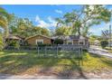 Charming single-Gathering home featuring a fenced front yard, well-maintained landscaping, and a welcoming facade at 2412 Giddens Ave, Seffner, FL 33584