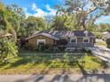 Lovely single-Gathering home featuring a fenced front yard and mature trees at 2412 Giddens Ave, Seffner, FL 33584