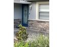 Close-up of a detailed front door with decorative glass and stone veneer at 2412 Giddens Ave, Seffner, FL 33584