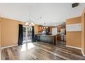 Bright living room with wood floors, sliding glass doors to the backyard, and open access to the kitchen at 2412 Giddens Ave, Seffner, FL 33584