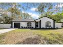 Charming single-story home featuring a freshly painted exterior, manicured lawn, and a convenient one-car garage at 2887 North Rd, Clearwater, FL 33760