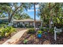 Inviting single-story home with well-manicured landscaping, walkway, and cozy front porch seating at 3026 51St S St, Gulfport, FL 33707
