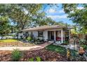 Inviting single-story home with well-manicured landscaping, walkway, and cozy front porch seating at 3026 51St S St, Gulfport, FL 33707
