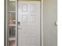 Traditional entrance door with sidelight windows adding character, enhancing the curb appeal of the property at 3050 Landmark Blvd # 1008, Palm Harbor, FL 34684