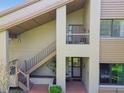 Welcoming exterior with a stairway leading to the upper level entrance and a charming, brick-lined front porch at 3050 Landmark Blvd # 1008, Palm Harbor, FL 34684