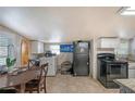 Kitchen featuring tile flooring, wooden table and black appliances at 3515 18Th E St, Bradenton, FL 34208