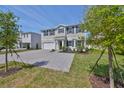 Beautiful two-story home with a gray brick driveway, manicured lawn, and inviting curb appeal at 3913 W Euclid Ave, Tampa, FL 33629