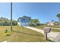 Lovely blue two-story home with a well maintained lawn and lush landscaping at 4010 Jewfish Dr, Hernando Beach, FL 34607
