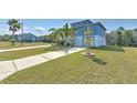 Quaint two-story home with lush landscaping, and a manicured lawn at 4010 Jewfish Dr, Hernando Beach, FL 34607