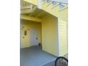 A ground-floor entrance of the condo building showing a covered entry and two adjacent doors at 455 Alt 19 S # 217, Palm Harbor, FL 34683