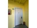 Close-up of an condo unit's entrance door with a security lock and a small storage box at 455 Alt 19 S # 217, Palm Harbor, FL 34683