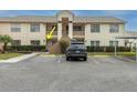 Exterior view of the building showcasing a car parked outside the apartment complex at 7807 Hardwick Dr # 115, New Port Richey, FL 34653