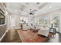 Bright living room with coffered ceilings, hardwood floors, fireplace, and large windows at 808 Idlewood Ave, Tampa, FL 33609