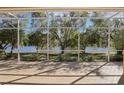 Relaxing screened patio with brick flooring offering scenic water views and a serene outdoor living space at 10211 Quails Landing Ave, Tampa, FL 33647