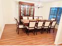 Traditional dining room featuring a wood table with seating for ten and a decorative china cabinet at 15013 Redcliff Dr, Tampa, FL 33625