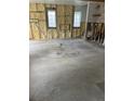 A spacious living room area featuring stud framing and insulation ready for customization and design ideas at 1751 Massachusetts Ne Ave, St Petersburg, FL 33703